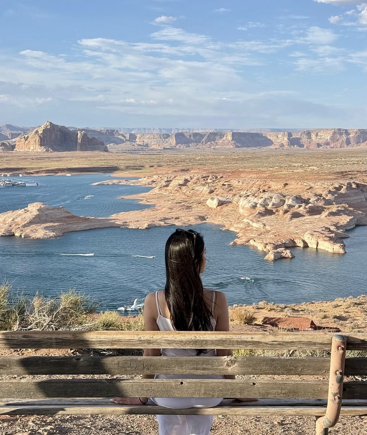 Woman on a bench looking over the coves and buttes of Lake Powell
